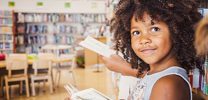Student reading in a classroom.