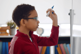 student doing problems on a whiteboard